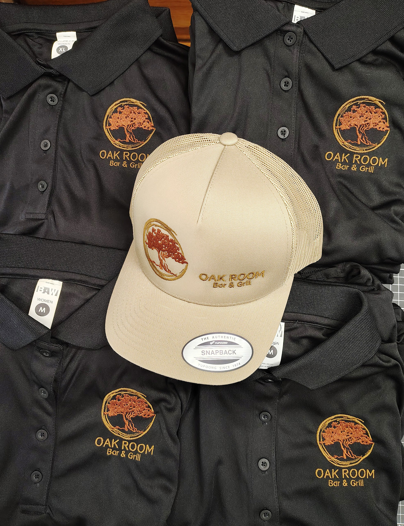 Cream custom cap displayed with matching embroidered business apparel